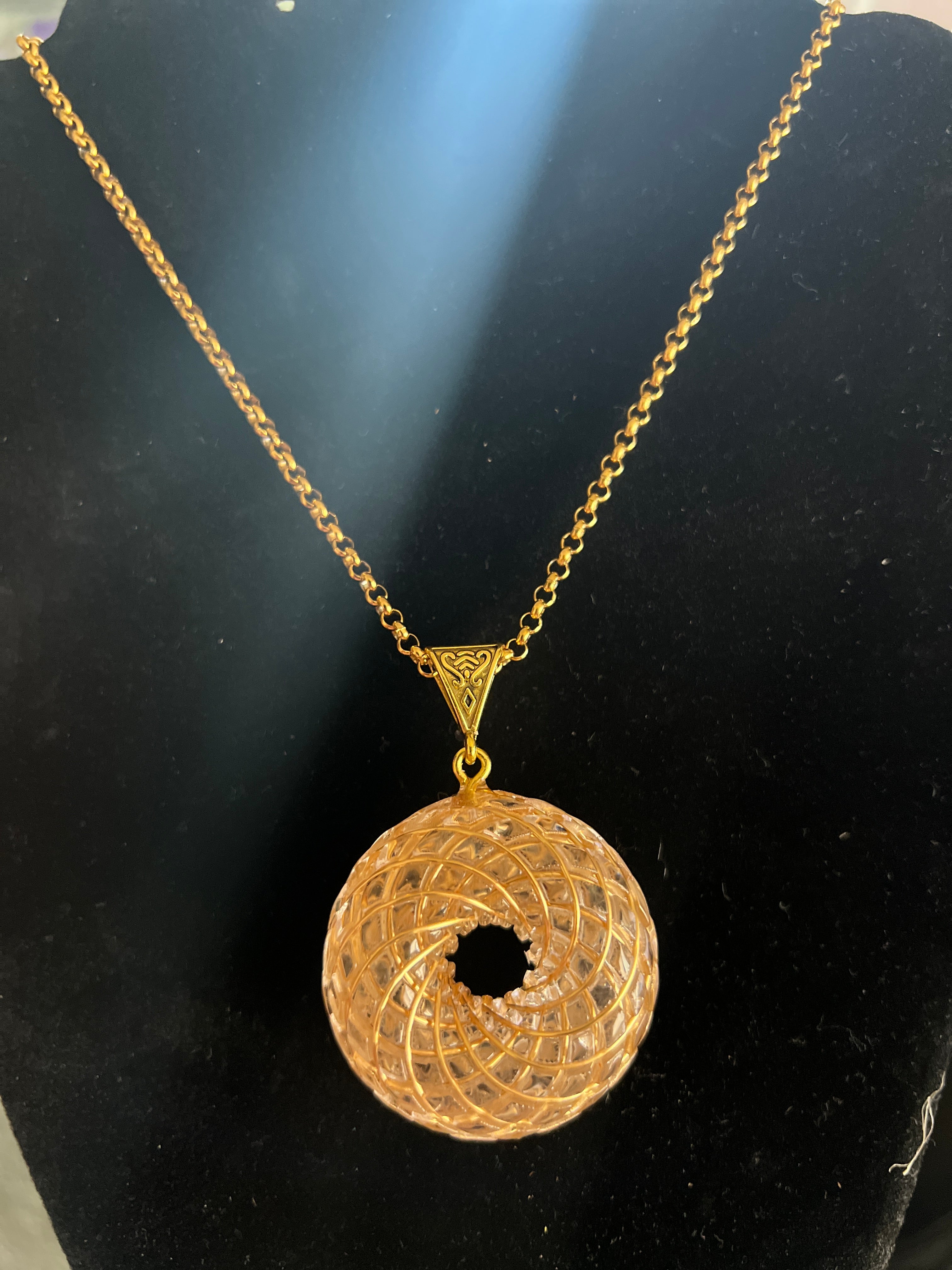 Rainbow Phenakite crystal 18K pendant with intricate gold design on matching gold chain